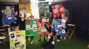 Group of children holding up their work at The Joinery