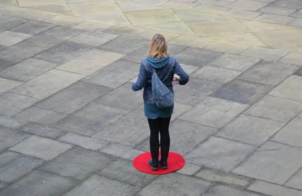 Rose condo standing on a red dot