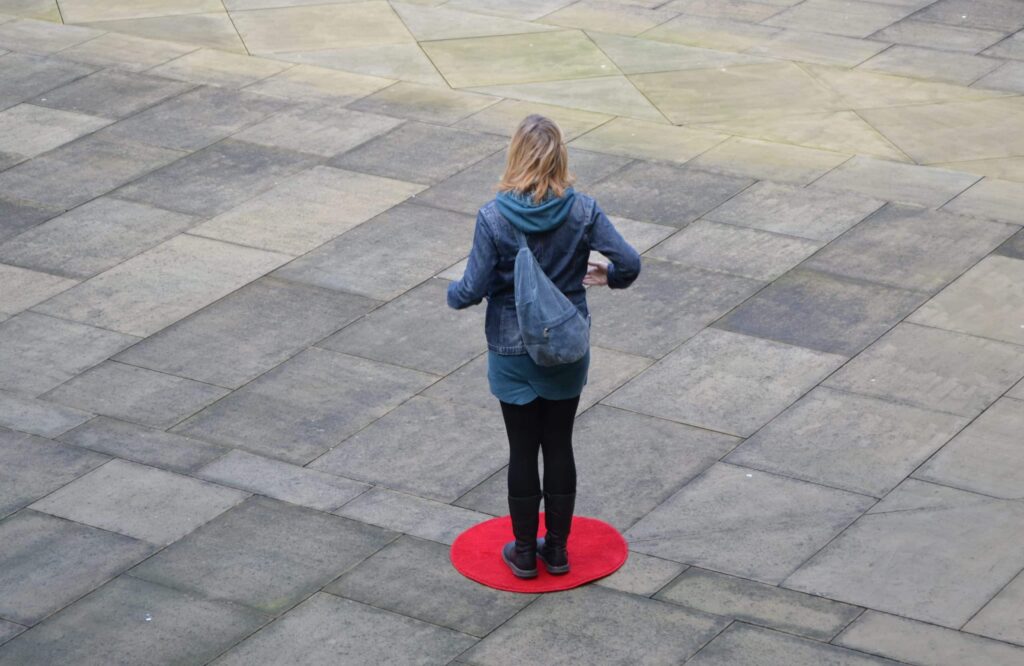 Rose condo standing on a red dot