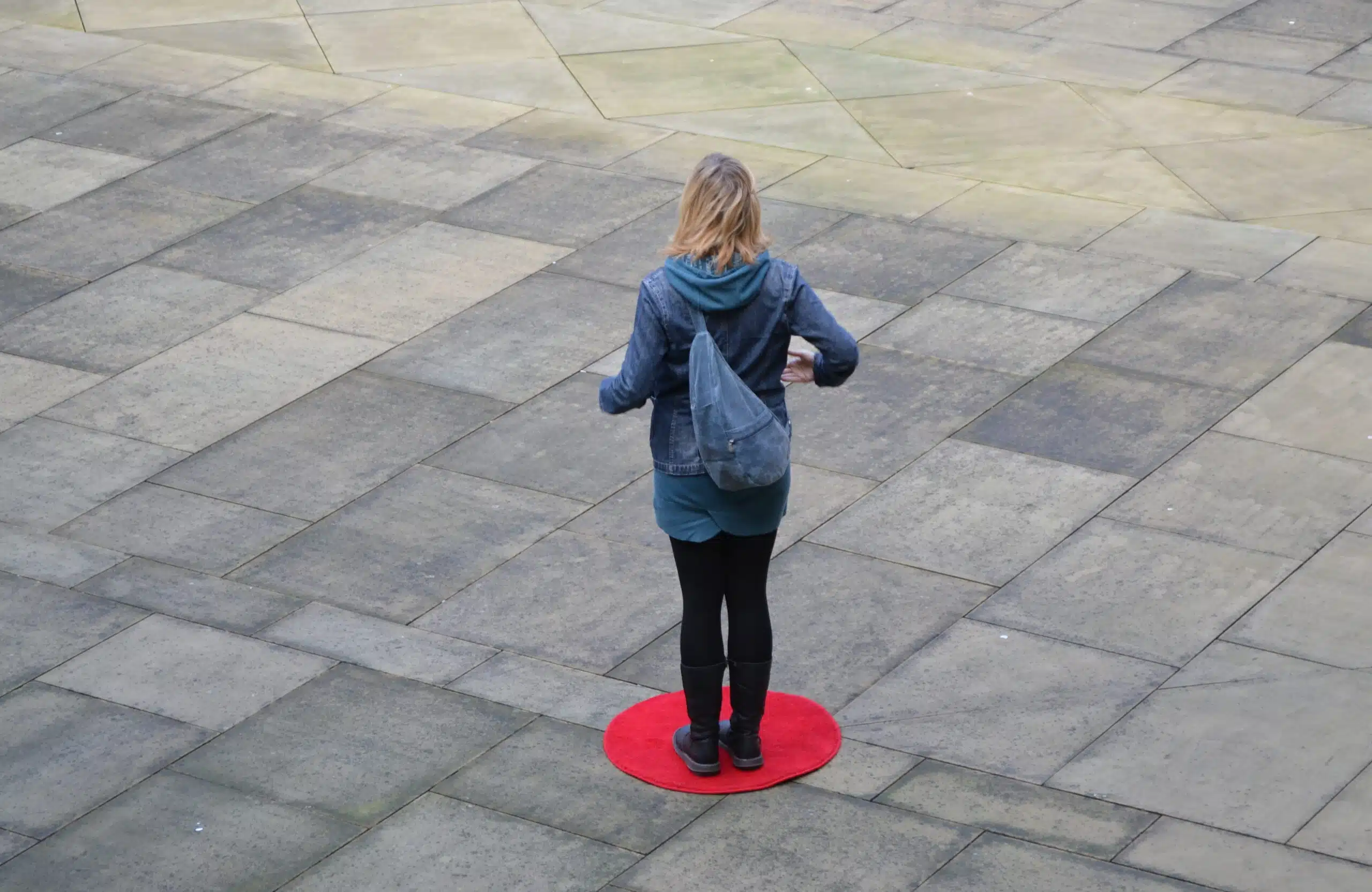 Rose condo standing on a red dot