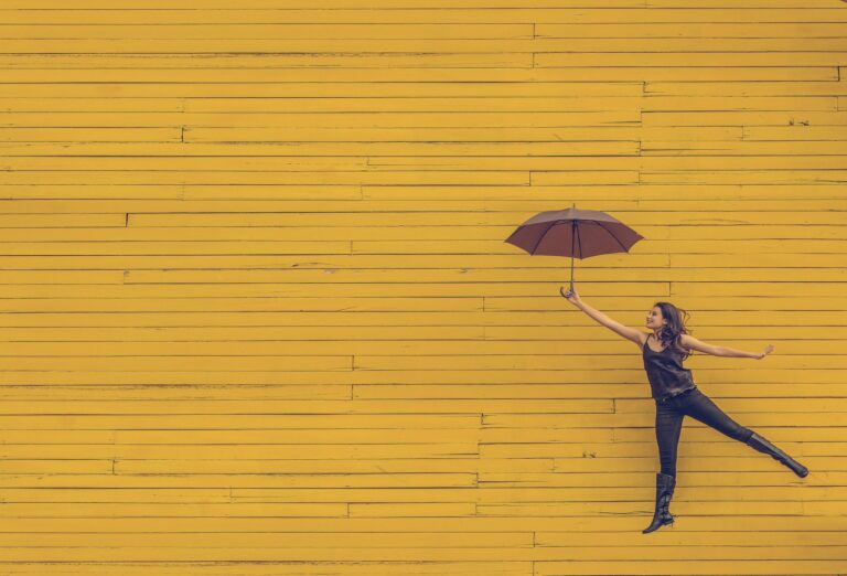 Woman holding umbrella and floating